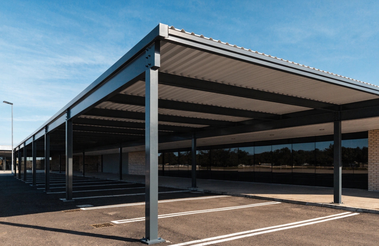 Steel-framed shade structure providing cover over a commercial car park